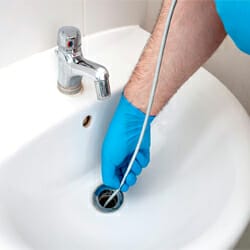 cleaning a sink with drain snake